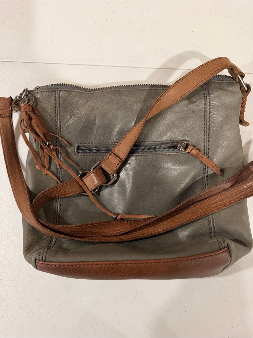 The Sak Gray Leather Crossbody with Tan Tassel Accent